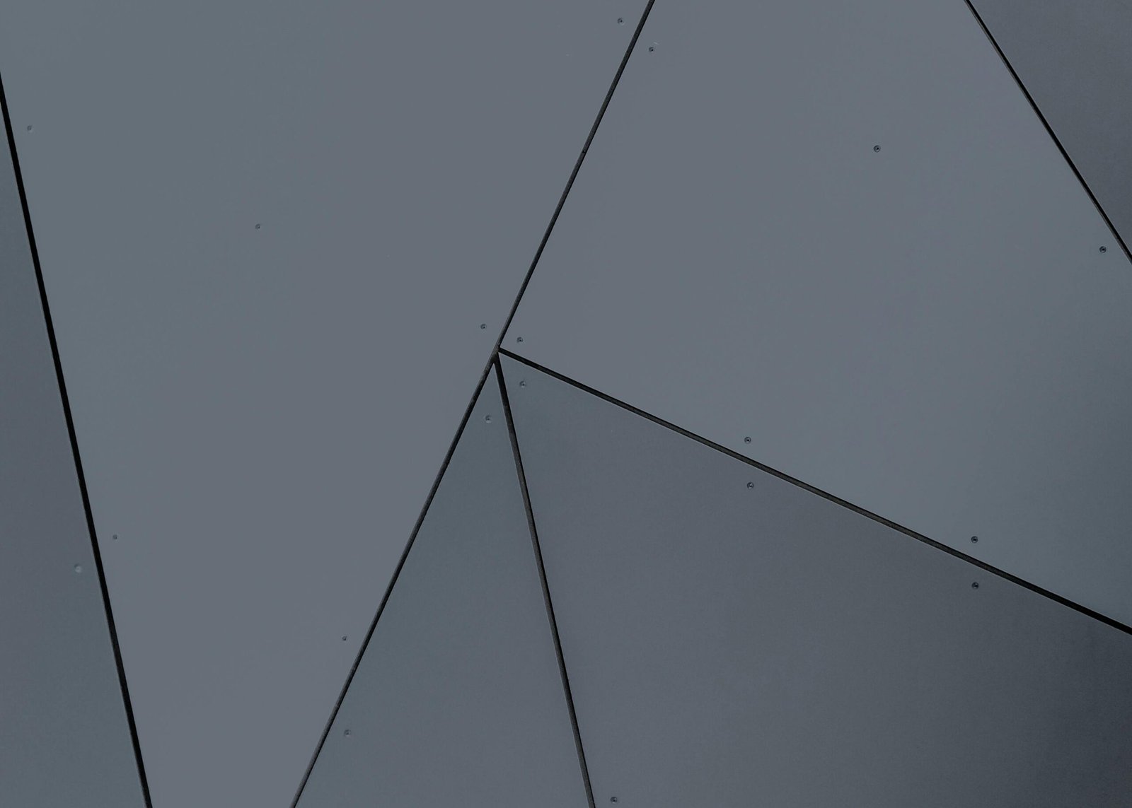 Abstract geometric facade with grey panels and sharp lines in London, Ontario.
